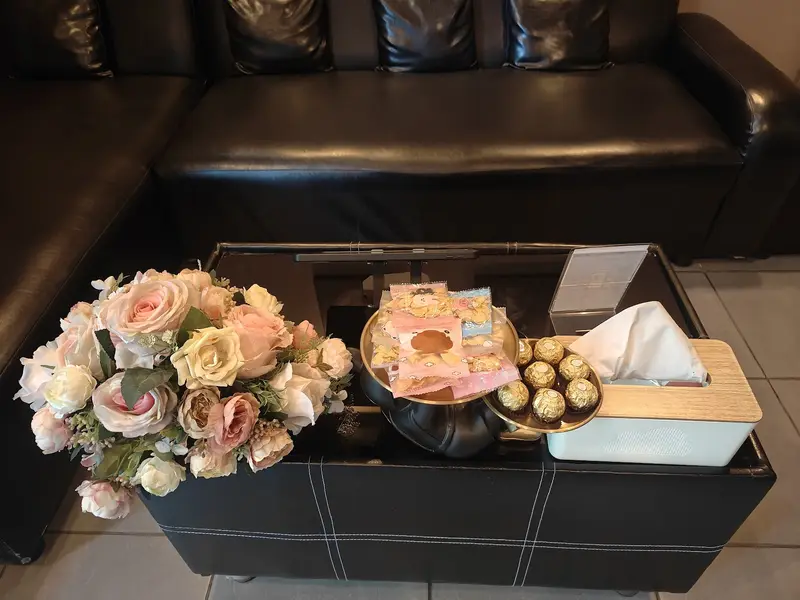 Pink roses, chocolates and snacks laid out on the lounge table